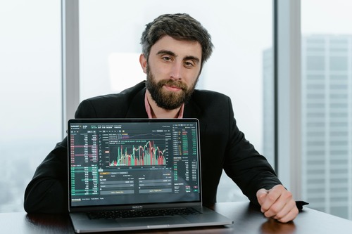 Trader reviewing a cryptocurrency exchange trading chart on a laptop screen